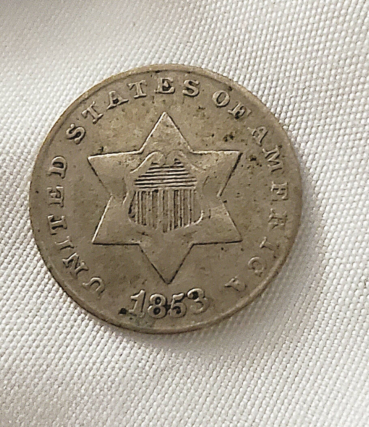 1853 honest to goodness solid three cent silver piece, always popular American coin