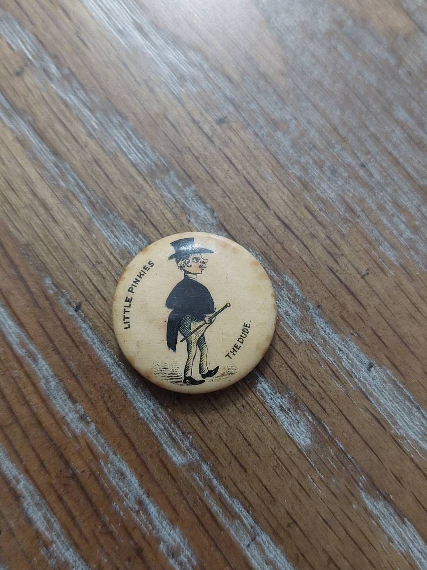 1890s whitehead and Hoag pinback, advertising token "the dude"