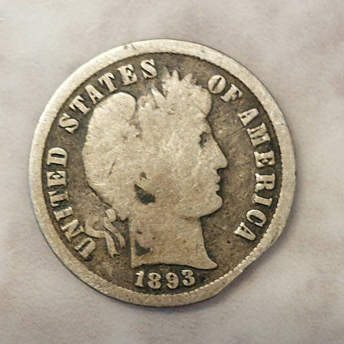 1893s barber silver dime, Scarce early date, a good coin. Planchet flaw or post mint damage I don't know..