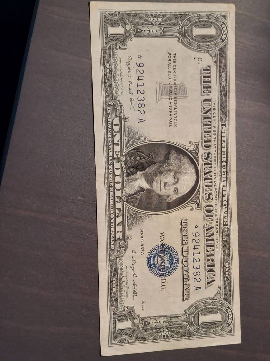 1957a one dollar silver certificate,  high grade blue seal STAR note American currency
