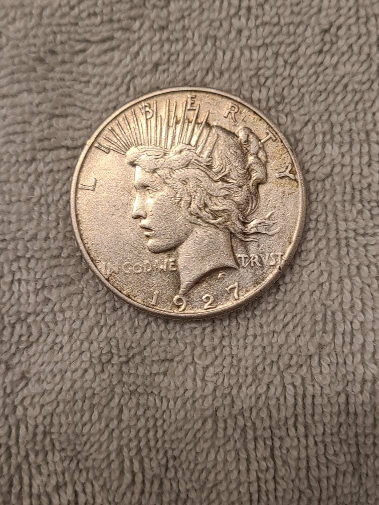1927s peace dollar, semi key date low mintage 90 percent silver