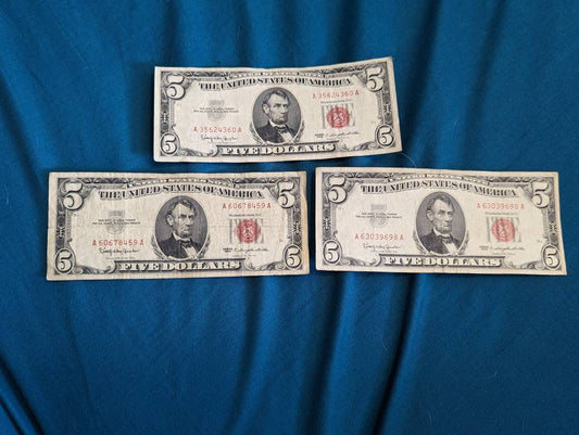 Three 1963 five dollar red seal currency note rare nice grade, old Americana paper money. Fifteen dollars face value.